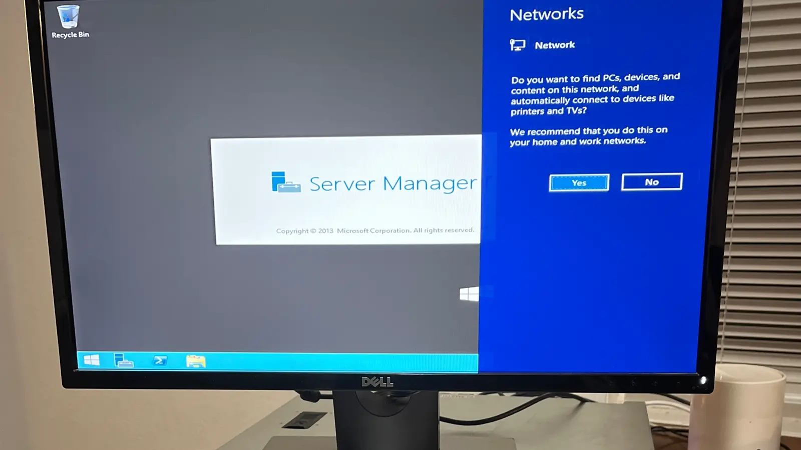 Server Manager dashboard displayed in front of Dell PowerEdge server hardware