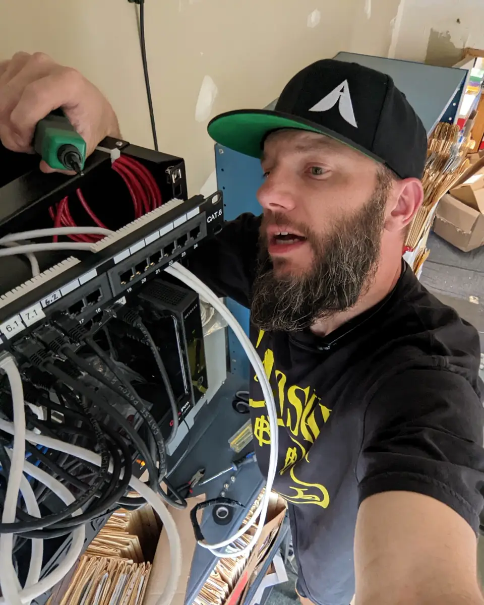 Tim Gelhardt working inside a network rack